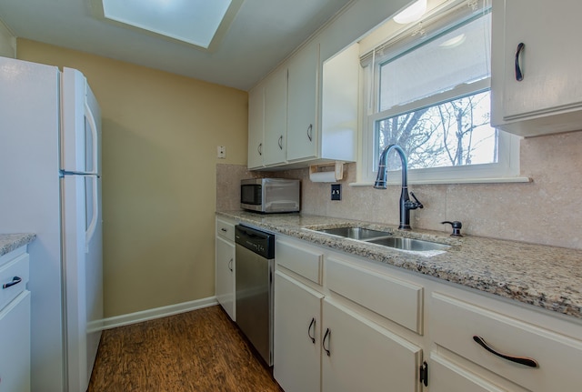 kitchen with white cabinetry, appliances with stainless steel finishes, sink, and dark hardwood / wood-style floors