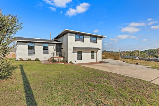 rear view of property featuring a yard