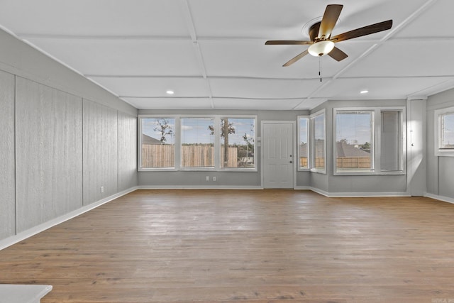 unfurnished sunroom featuring coffered ceiling and ceiling fan