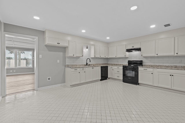 kitchen featuring white cabinetry, light stone countertops, sink, and black appliances