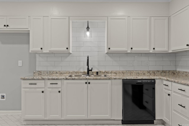 kitchen featuring light stone countertops, black dishwasher, sink, and white cabinets