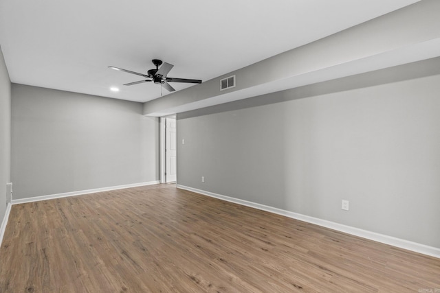 empty room featuring hardwood / wood-style flooring and ceiling fan