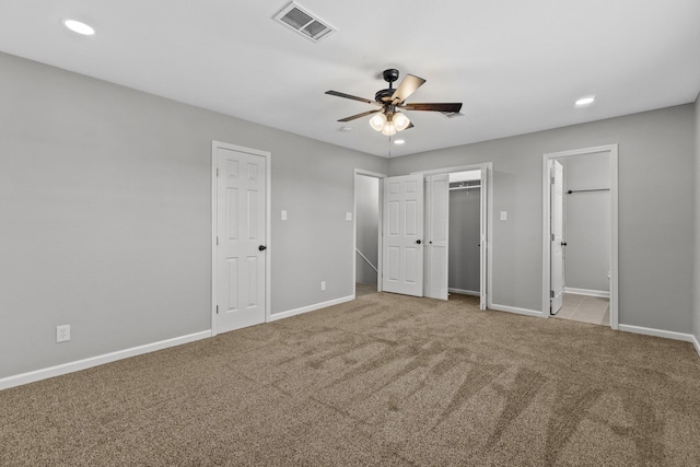 unfurnished bedroom with light carpet, ceiling fan, and ensuite bathroom