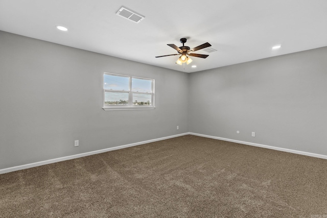 spare room featuring carpet floors and ceiling fan