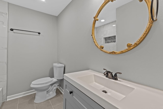 bathroom featuring vanity, tile patterned floors, and toilet