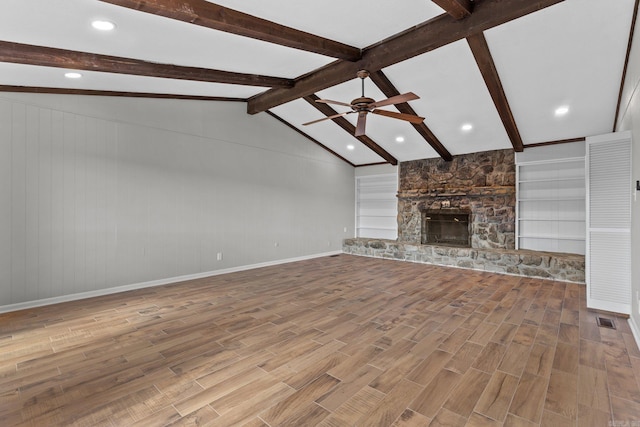 unfurnished living room with light hardwood / wood-style flooring, a fireplace, lofted ceiling with beams, and ceiling fan