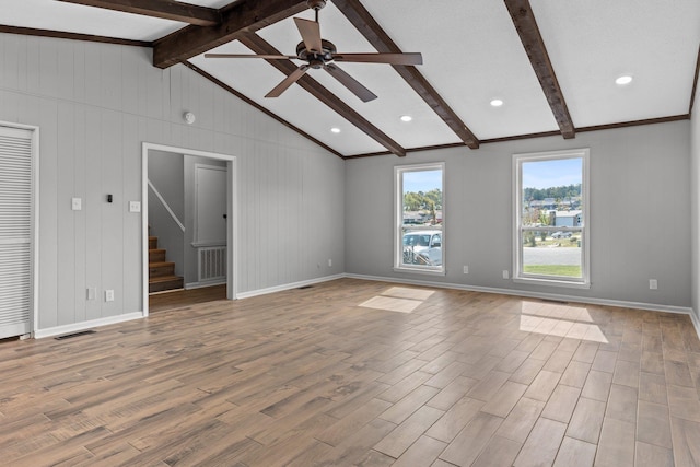 unfurnished living room featuring lofted ceiling with beams and ceiling fan