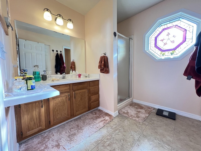 bathroom with vanity and a shower with door