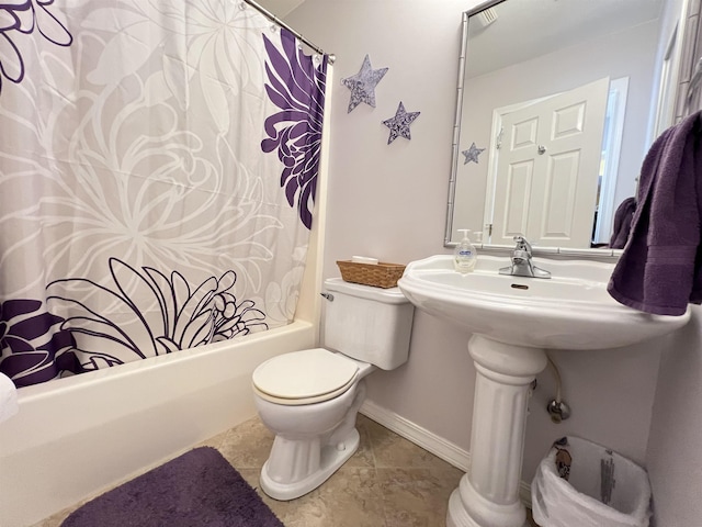 bathroom featuring toilet, tile patterned flooring, and shower / tub combo