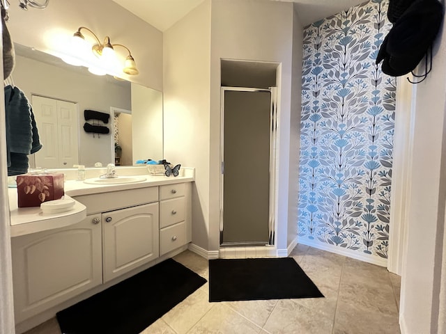 bathroom featuring vanity, tile patterned floors, and a shower with shower door