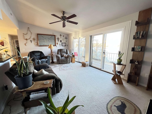 carpeted living room with vaulted ceiling and ceiling fan