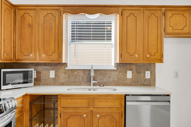 kitchen featuring tasteful backsplash, appliances with stainless steel finishes, and sink