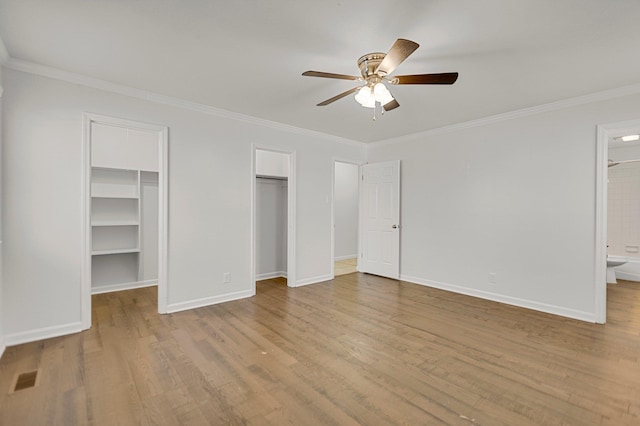 unfurnished bedroom with crown molding, ensuite bath, and ceiling fan