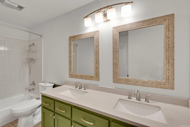 full bathroom with tiled shower / bath combo, vanity, and toilet