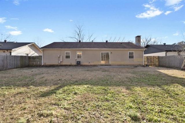 rear view of property featuring a yard, central AC unit, and a patio area