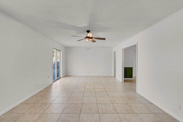 spare room with ceiling fan and light tile patterned floors