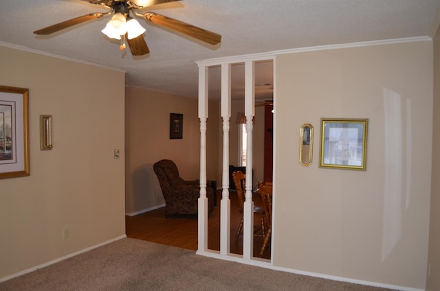 carpeted spare room featuring crown molding, ceiling fan, and a textured ceiling