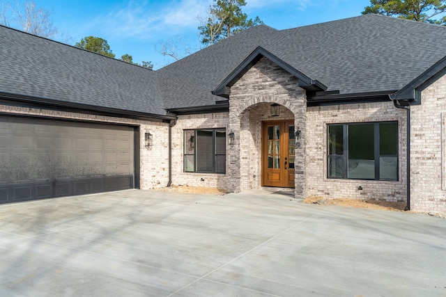 view of front of property with a garage and french doors