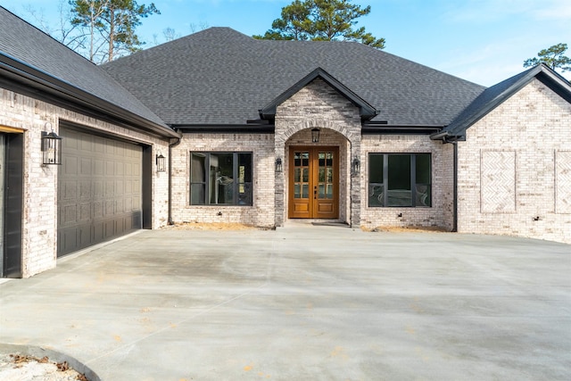 view of front facade featuring a garage and french doors