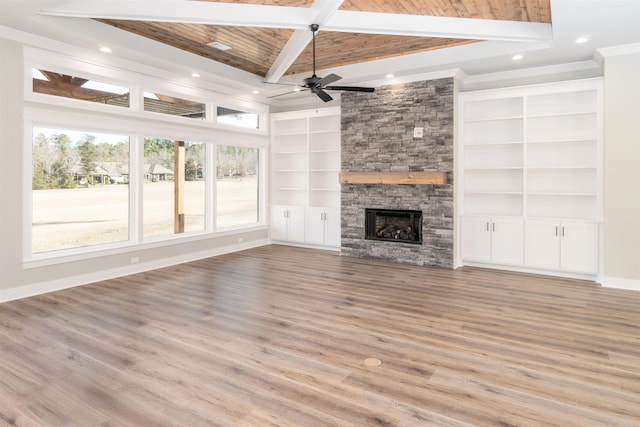 unfurnished living room featuring a fireplace, light hardwood / wood-style floors, wooden ceiling, beam ceiling, and built in shelves