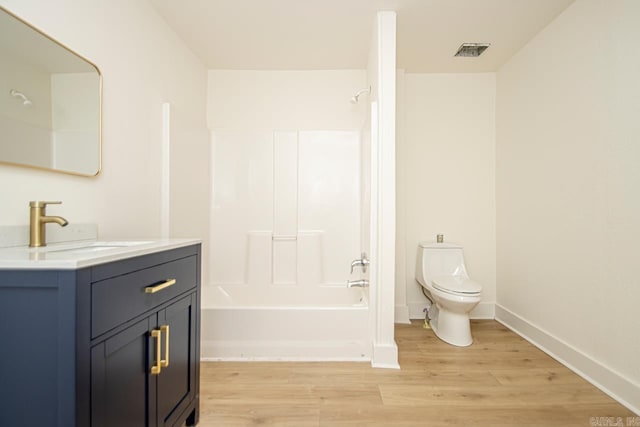 full bathroom featuring hardwood / wood-style flooring,  shower combination, toilet, and vanity