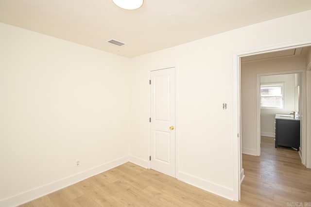 spare room with light wood-type flooring