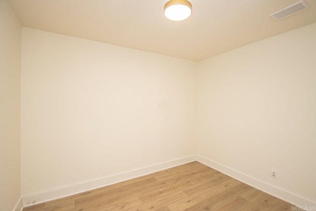 unfurnished room with wood-type flooring