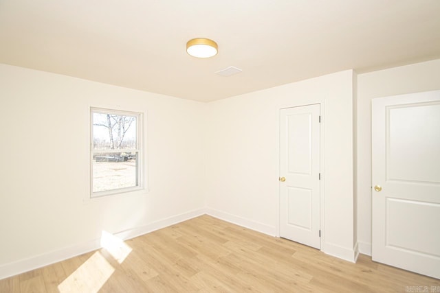 spare room featuring light wood-type flooring