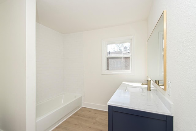 bathroom featuring vanity, hardwood / wood-style flooring, and bathtub / shower combination