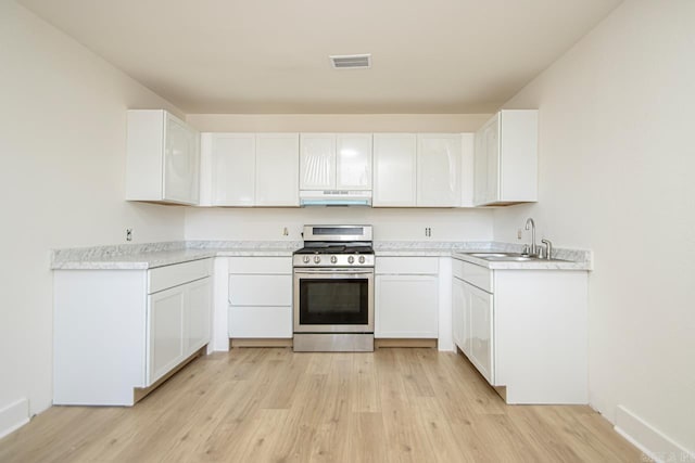 kitchen featuring white cabinetry, sink, light hardwood / wood-style floors, and gas stove