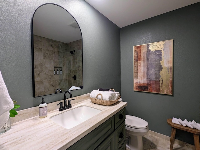 bathroom featuring tile patterned flooring, vanity, and toilet