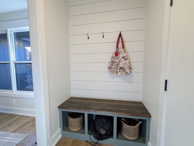 mudroom featuring light hardwood / wood-style flooring and wood walls