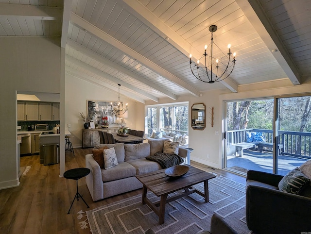 living room with plenty of natural light, dark wood-type flooring, vaulted ceiling with beams, and a notable chandelier