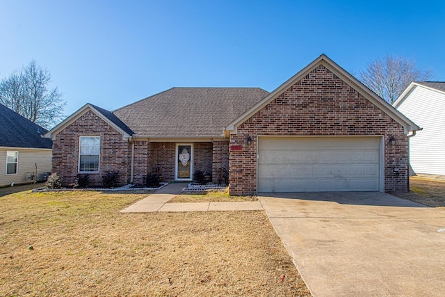 view of front of house featuring a garage and a front lawn