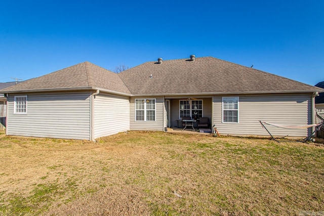 back of property with a patio area and a lawn