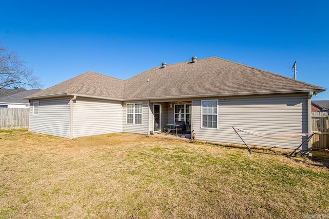 back of property with a yard and a patio area