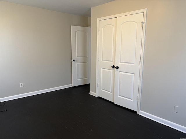 unfurnished bedroom featuring dark hardwood / wood-style flooring