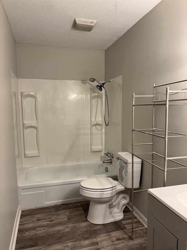 full bathroom with toilet,  shower combination, a textured ceiling, vanity, and hardwood / wood-style flooring