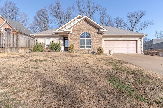 view of front facade with a garage and a front lawn