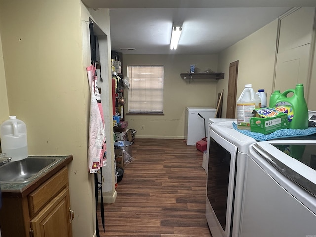 laundry room with dark wood-type flooring and washer and clothes dryer