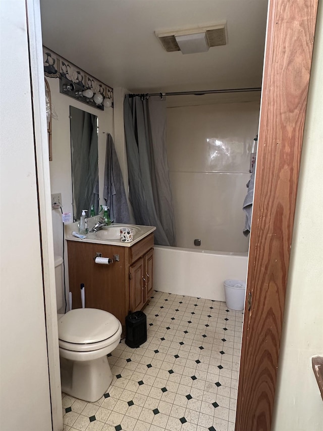 full bathroom featuring vanity, shower / tub combo with curtain, and toilet