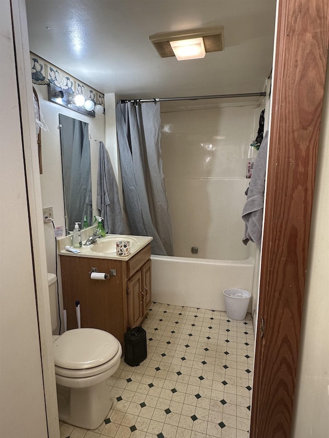 full bathroom featuring vanity, shower / bath combination with curtain, and toilet