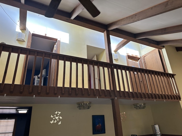 stairs featuring beam ceiling