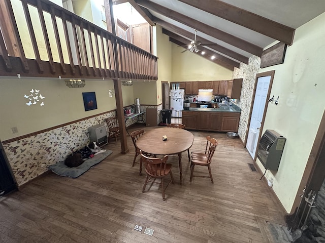 dining area with heating unit, hardwood / wood-style floors, high vaulted ceiling, beamed ceiling, and ceiling fan