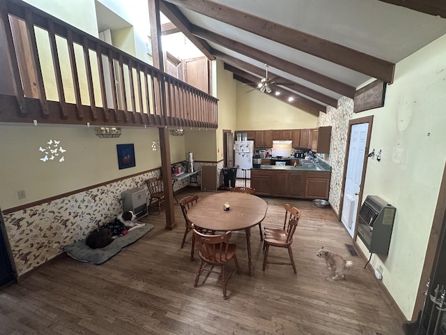 dining area featuring hardwood / wood-style flooring, ceiling fan, high vaulted ceiling, heating unit, and beamed ceiling