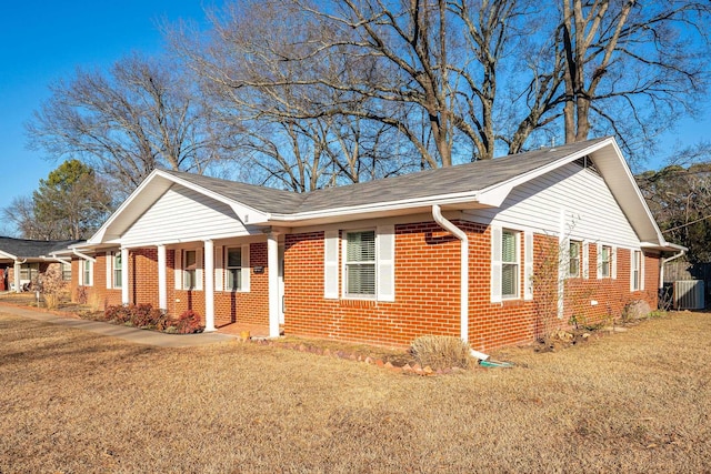 single story home featuring central AC unit and a front lawn