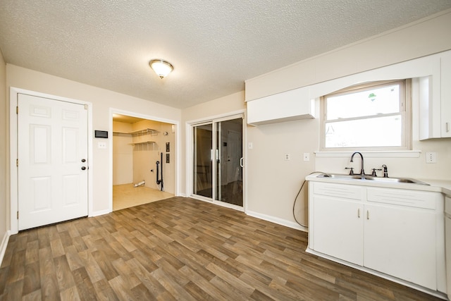 kitchen featuring white cabinetry, sink, and a textured ceiling