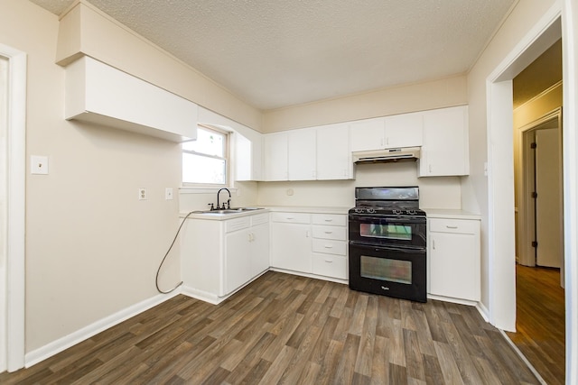 kitchen with sink, dark wood-type flooring, white cabinetry, double oven range, and a textured ceiling