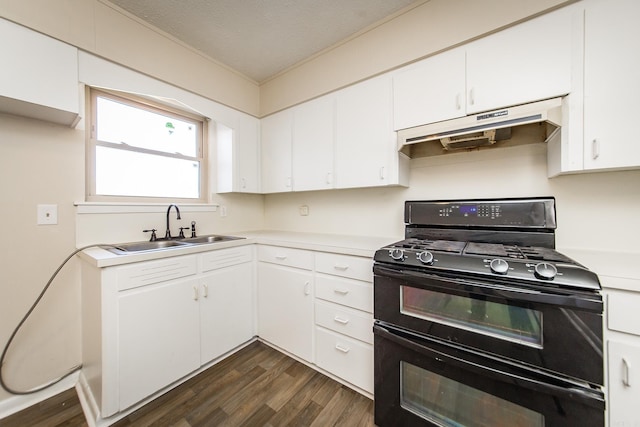 kitchen with white cabinetry, double oven range, and sink