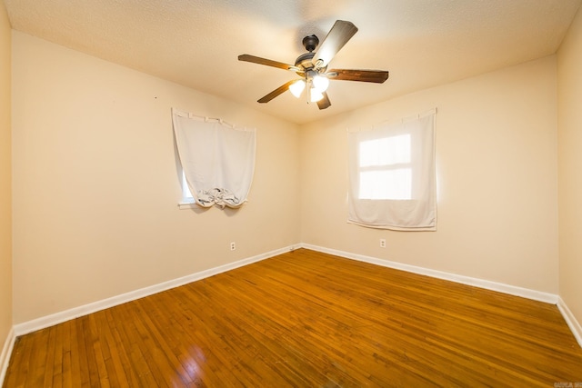 empty room featuring hardwood / wood-style flooring and ceiling fan